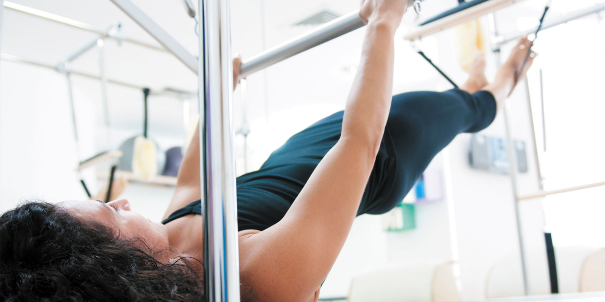 Woman using Pilates equipment